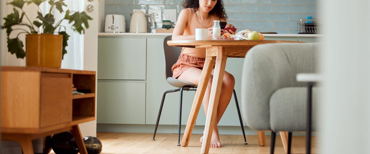 Diet, healthy life and food of a hygienic female sitting alone looking up nutrition value of an app.