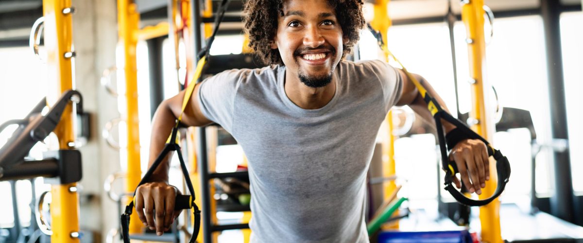 Healthy life and gym exercise. Handsome fit man working out in health club