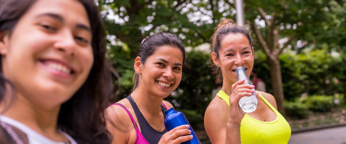 Girls doing sports in a park in the city, lifestyle a healthy life, taking a selfie with the phone after finishing training